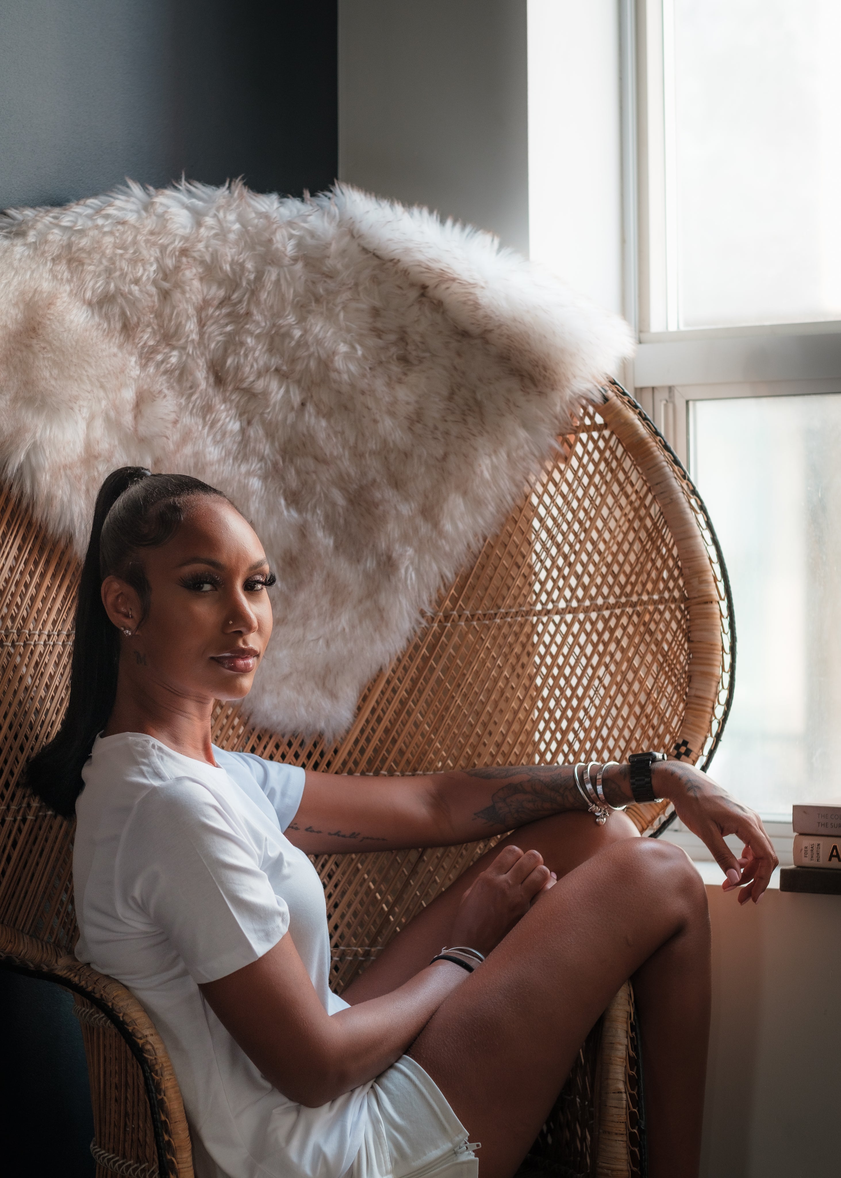 files/woman-dressed-in-white-t-shirt-in-a-wicker-peacock-chair.jpg