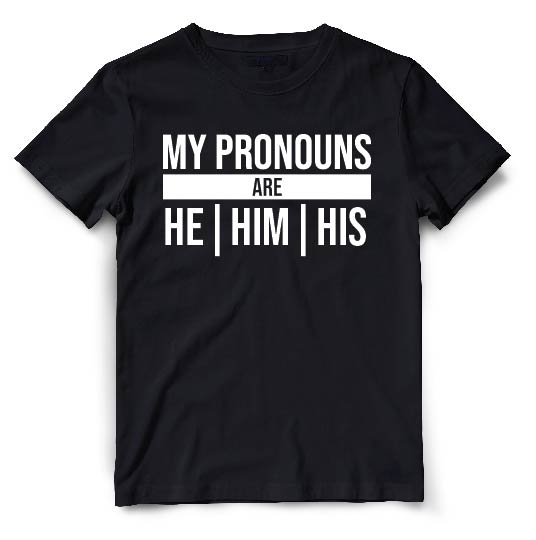 This black t-shirt is a simple yet powerful expression of gender inclusivity. The front of the shirt features white typography that reads "My Pronouns Are" followed by the wearers chosen pronouns.